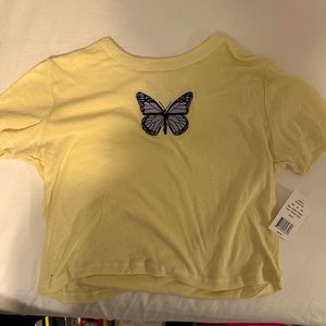 Pale yellow cropped T-shirt with embroidered butterfly stitching.